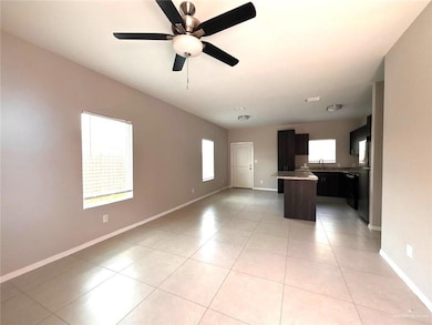 Unfurnished living room with plenty of natural light, light tile patterned floors, and ceiling fan