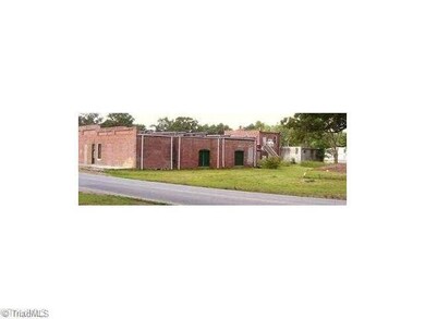 Exterior Back. Back view and vacant lot for parking.