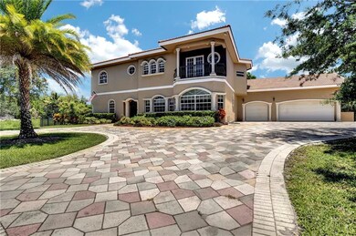 Paver driveway, three car garage and impact window