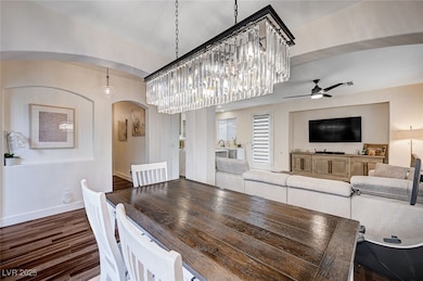 Dining area with baseboards, arched walkways, dark
