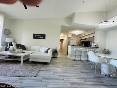 Living area featuring ceiling fan and wood tiled floors