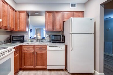 Kitchen has beautiful real wood cabinets