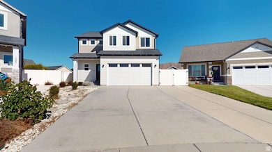 View of front facade with concrete driveway, a gate, and an attached garage
