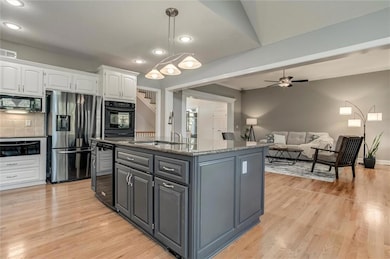 Large island in kitchen opens to dining and living room
