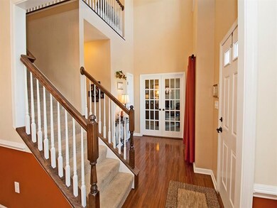 Large entry with beautiful shiny floors create a n