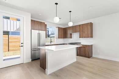 Kitchen featuring a kitchen island, light wood-st