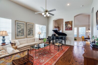 Living room with lofted ceiling, ceiling fan, and 