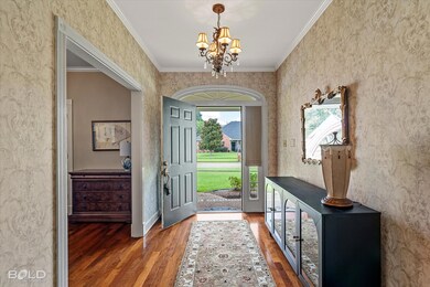 Foyer entrance featuring an inviting chandelier, w