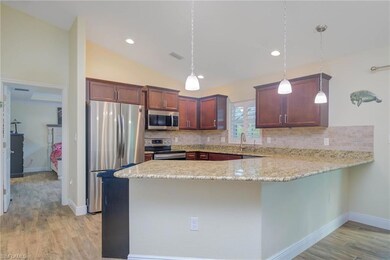 Kitchen featuring pendant lighting, appliances wit