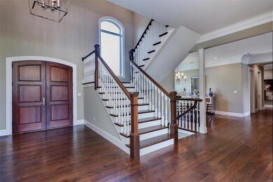The Foyer welcomes you with 20' ceilings and a lig