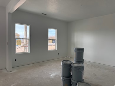 Empty room featuring a textured ceiling and concrete flooring