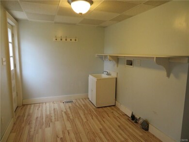 Large first floor laundry room with utility sink.