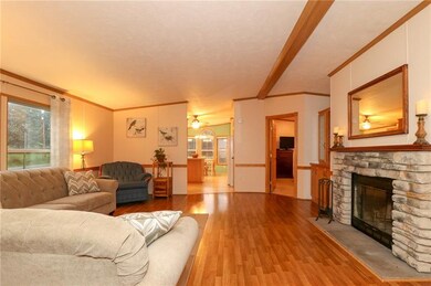 THE LIVING ROOM FEATURES A LOG BURNING FIREPLACE W