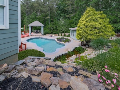 Outdoor pool featuring a gazebo and a patio area