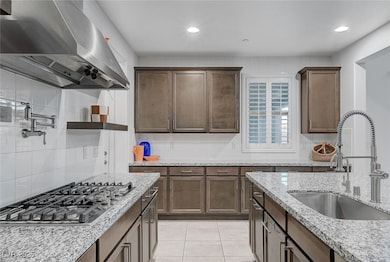 Kitchen featuring ventilation hood, stainless stee