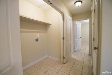 Laundry room featuring hookup for a washing machine and light tile patterned flooring