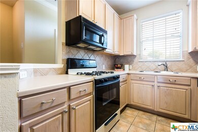 Kitchen with range and built-in microwave.