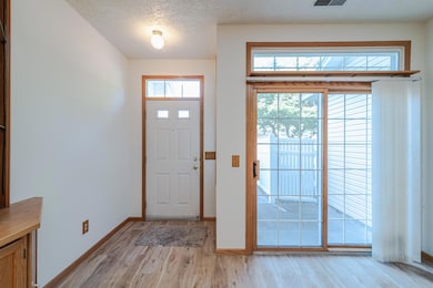 Bright entry with a window above the door