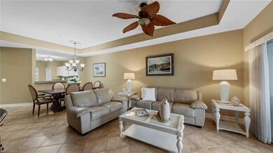 Living room with a tray ceiling, ceiling fan with 