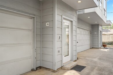 Private entryway with a modern glass-paneled door,