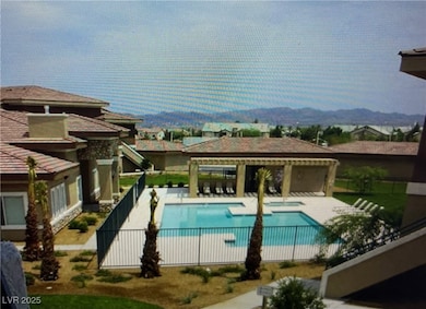 Community pool featuring a patio area, fence, a mo