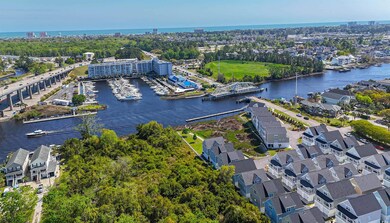 Birds eye view of property with a water view and a