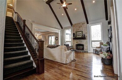 Living room features vaulted wood beamed ceilings,