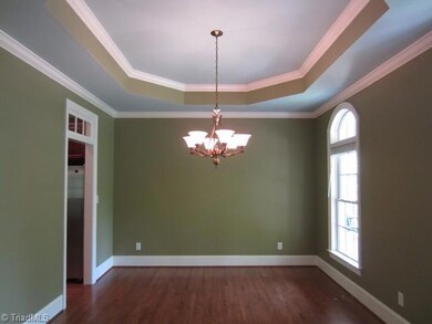 Dining Room.  This room is capable of holding a very long table and many pieces of furniture like side boards and cupboards.  Two arched windows add elegance to the room, as does the beautiful tray ceiling and the double French doors from the foyer.