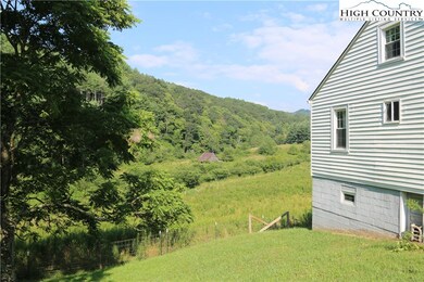 The fenced pasture is out back with wooded hillsid