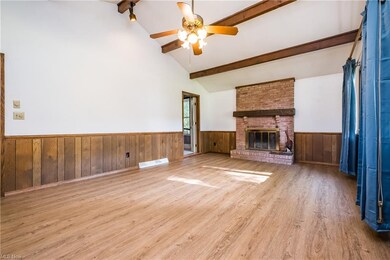 Great room with beamed cathedral ceilings and fireplace.