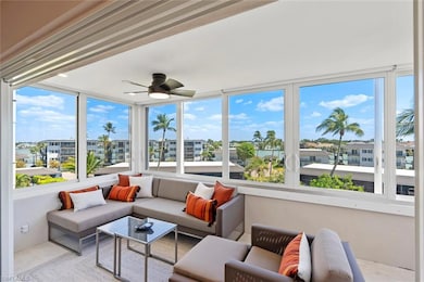 Sunroom featuring a wealth of natural light and a ceiling fan