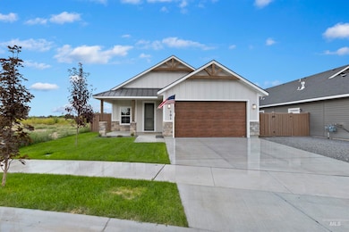 Craftsman-style home featuring stone siding, a porch, an attached garage, and board and batten siding