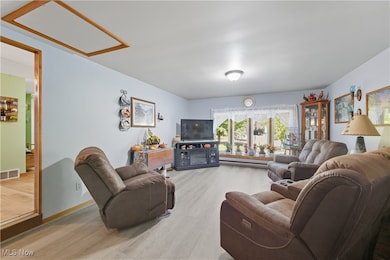 Living room featuring light wood-style flooring and baseboard heating
