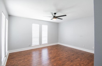 Empty room featuring dark wood-style floors, a cei