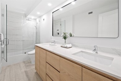 Remodeled modern bathroom features.