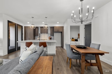 Dining room featuring dark wood-style floors, a chandelier, and recessed lighting