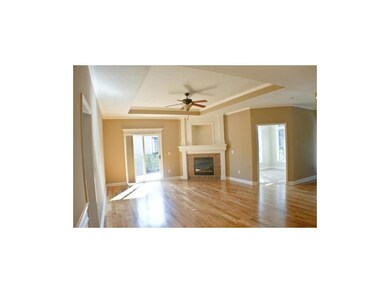 sun filled great room features gleaming hardwood f