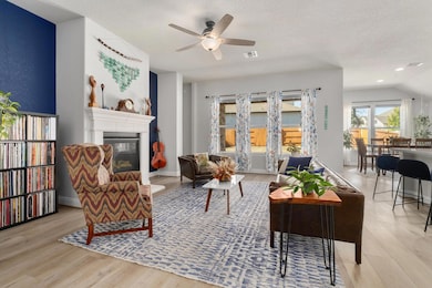 Warm and inviting living room with luxury vinyl flooring and a gas log fireplace.