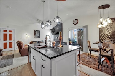 Kitchen featuring a sink, a textured ceiling, open