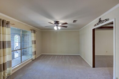 Dining/Living  with a ceiling fan, crown molding, 