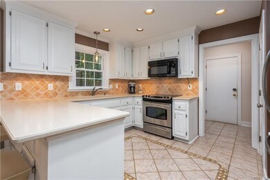 Kitchen to the drop-zone and half-bath and garage door.