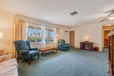 Living area with a ceiling fan, a textured ceiling