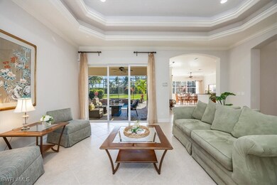 Living room sliders to outdoor living space and pool and entry to kitchen and dining