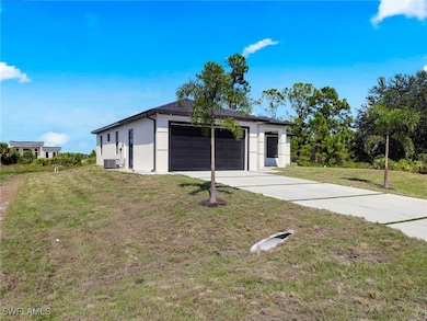 Garage featuring concrete driveway