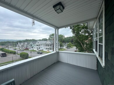 Front, outdoor porch, sitting area.