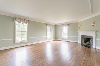 The spacious airy formal living room boasts soft s