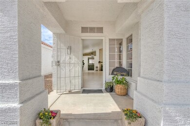 Doorway to property with visible vents and stucco