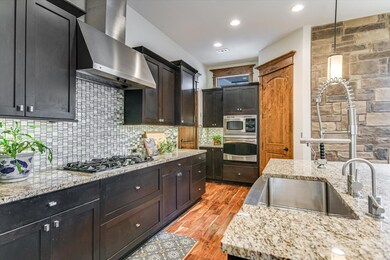 Kitchen with decorative light fixtures, tasteful 