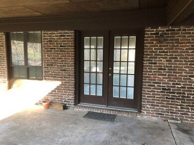 Door to kitchen under carport