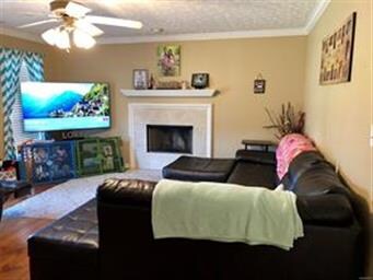 Large living area with fireplace and easy-care lam
